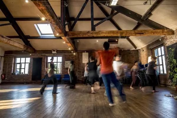 Photo of blurry people moving in a studio