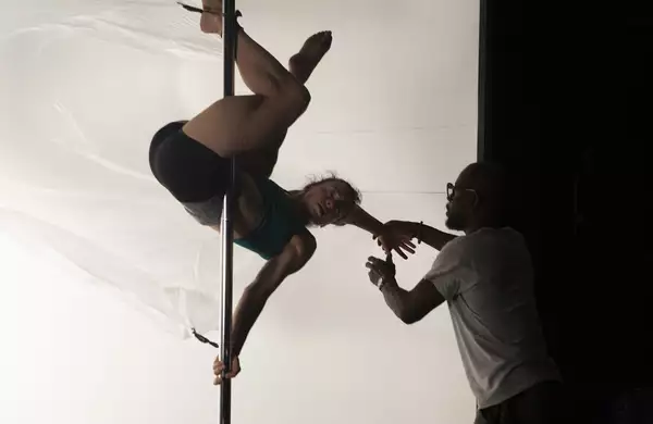 Photo of a person doing acrobatics on stage during Find Your Eyes rehearsal