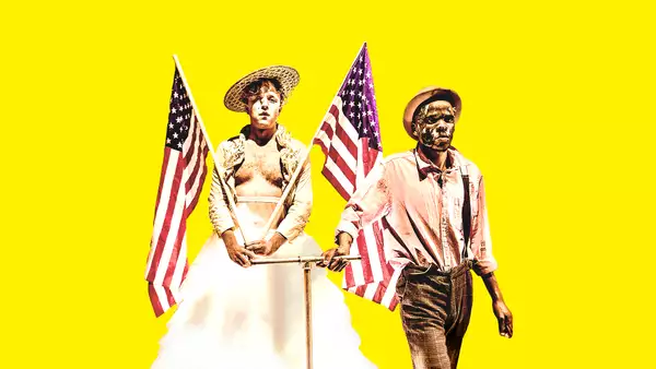 Two people holding two American flags on a yellow background