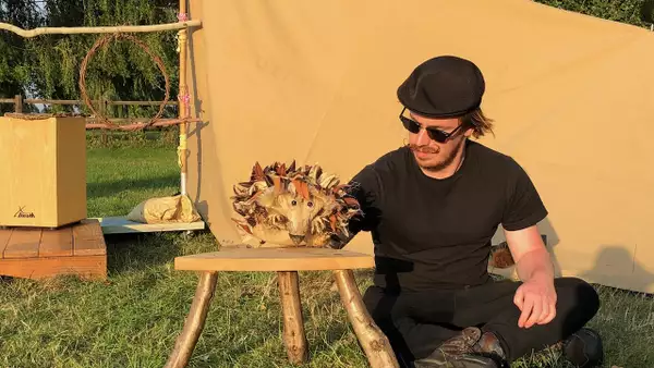 Photo of a person performing with a hedgehog puppet