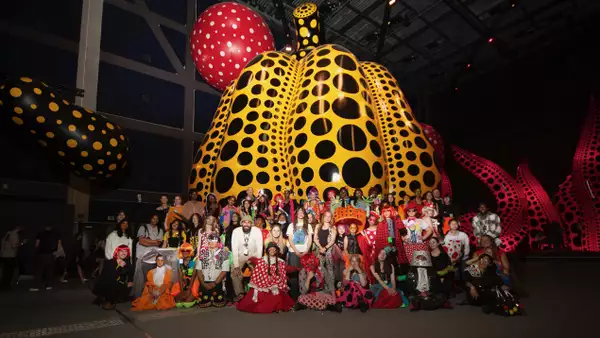 Image of a big group of people and children in the Kusama exhibition