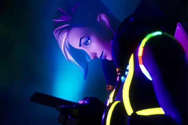 A screenshot of LaTurbo Avedon in Fortnite Creative - they are shot from the left side, and their face is lit by the blue light of the phone they are looking at.