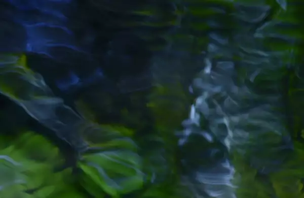 This image features a soft, abstract blend of dark blues and greens with flowing, ripple-like patterns, resembling light filtered through water or reflections on a moving surface.