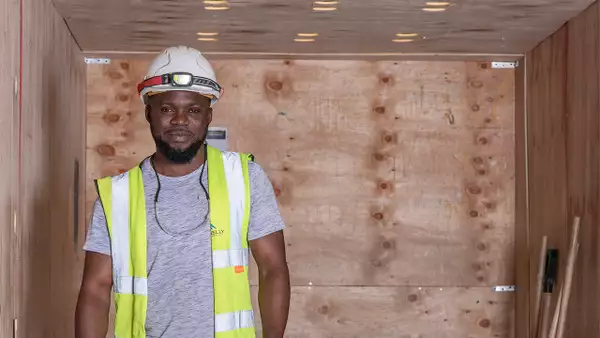 Photo of a worker wearing a helmet and hi vis