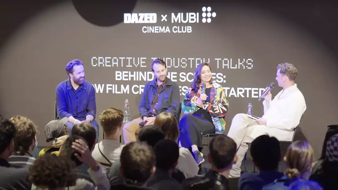 Four panelists sit on stage in front of an audience at an event titled "Creative Industry Talks: Behind the Scenes" hosted by DAZED and MUBI Cinema Club, discussing how film creators get started.