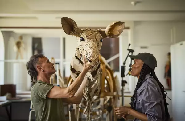 Life-sized puppet of a deer made of cardboard and metal